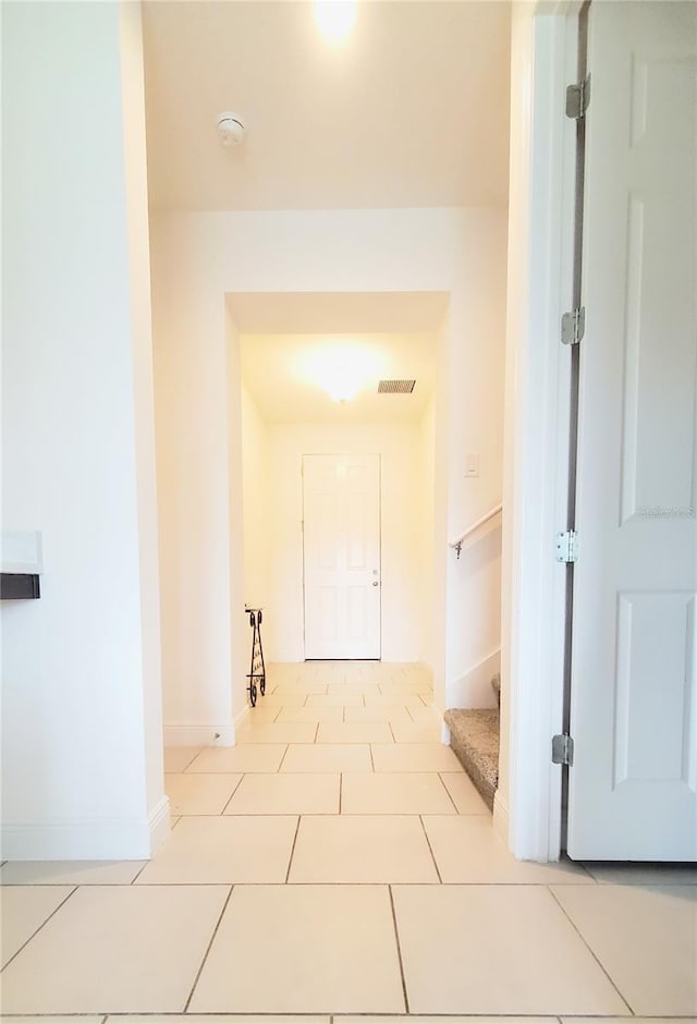 hall featuring light tile patterned floors