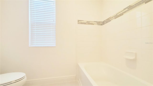 bathroom with a tub and toilet