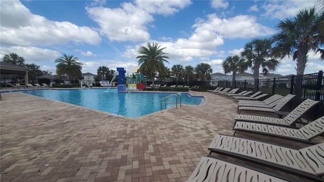 view of swimming pool featuring a patio and a water slide