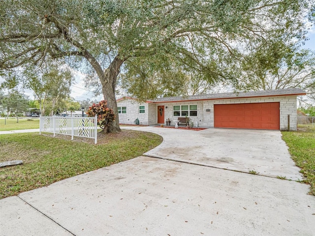 view of front of property featuring a garage and a front yard