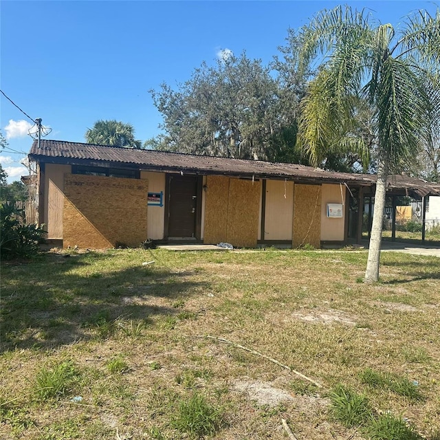 back of property featuring a yard