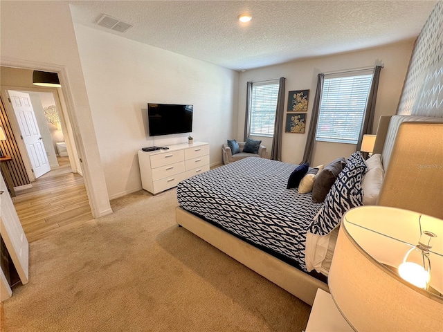 carpeted bedroom featuring a textured ceiling