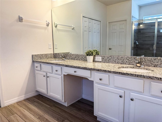 bathroom featuring vanity, hardwood / wood-style floors, and an enclosed shower