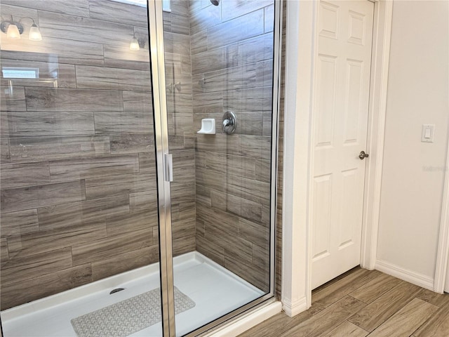 bathroom with hardwood / wood-style floors and walk in shower