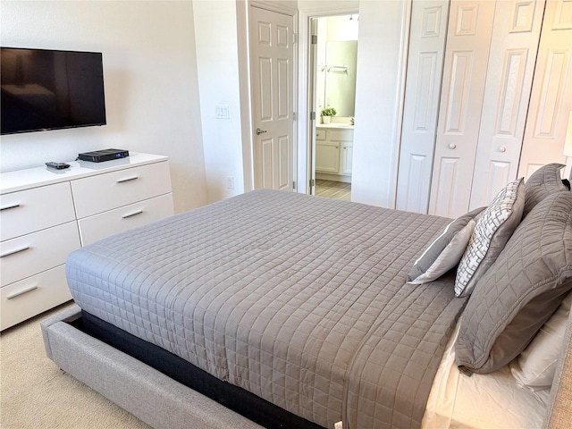 carpeted bedroom featuring connected bathroom and a closet