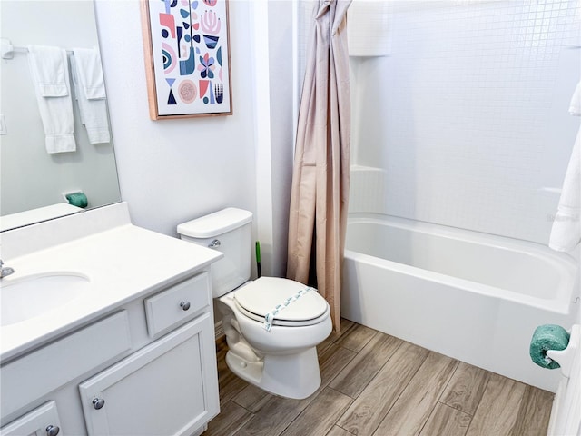 full bathroom with vanity, shower / tub combo, and toilet