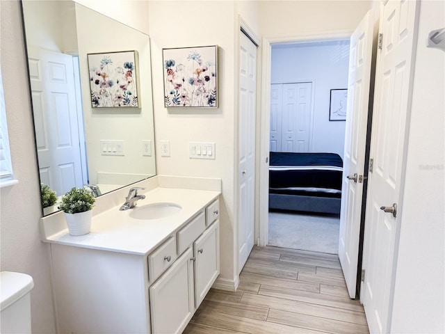 bathroom featuring vanity and toilet