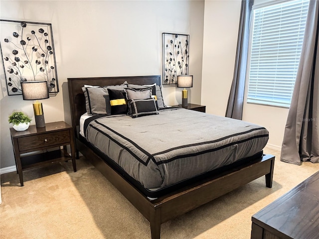 bedroom featuring light colored carpet