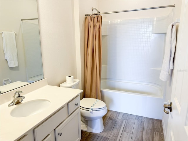 full bathroom featuring hardwood / wood-style flooring, shower / tub combo with curtain, vanity, and toilet