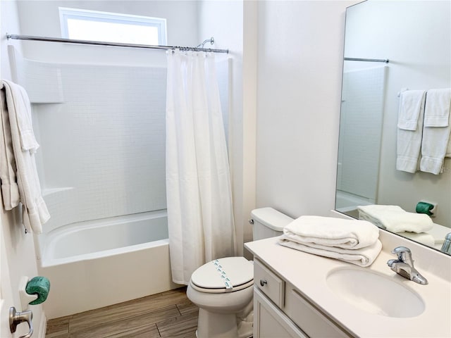 full bathroom with hardwood / wood-style flooring, vanity, shower / tub combo with curtain, and toilet