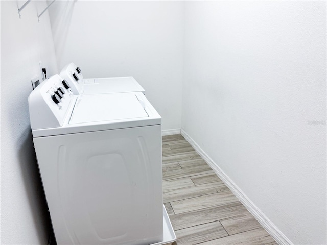 clothes washing area featuring separate washer and dryer