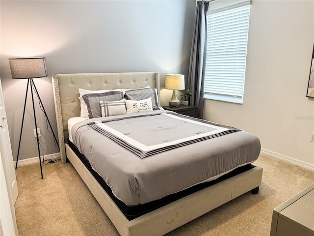 bedroom featuring light colored carpet