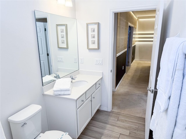 bathroom featuring hardwood / wood-style flooring, vanity, and toilet