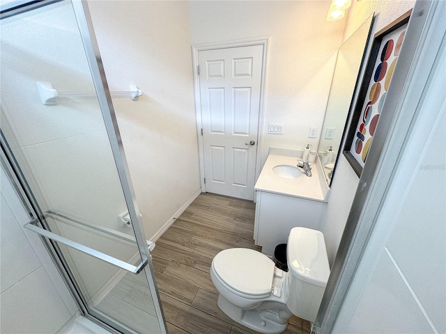 bathroom featuring vanity, toilet, and an enclosed shower