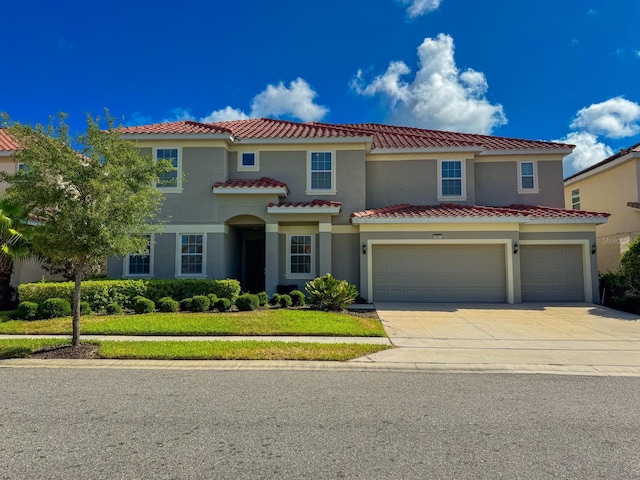 mediterranean / spanish home featuring a garage and a front lawn