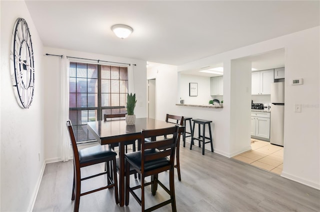 dining space featuring light wood-type flooring