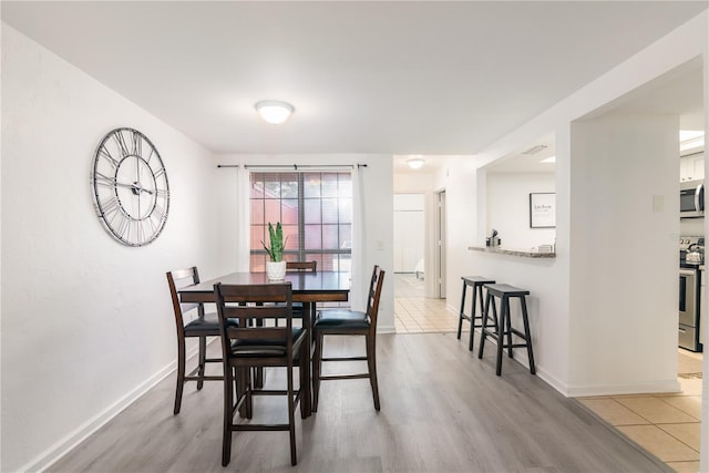 dining space featuring light hardwood / wood-style flooring