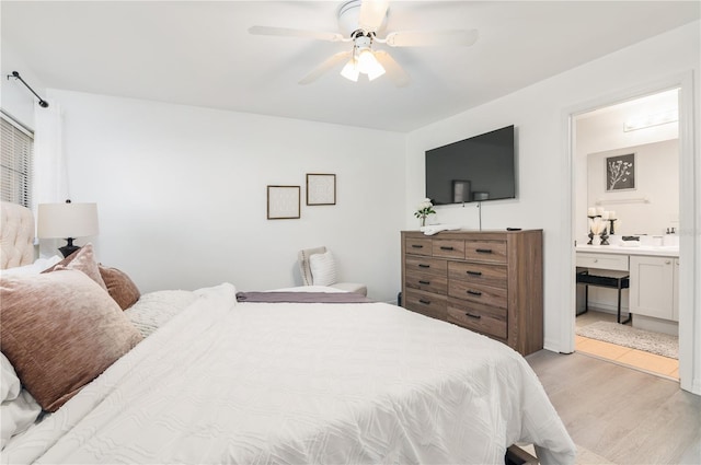 bedroom featuring connected bathroom, light hardwood / wood-style floors, and ceiling fan