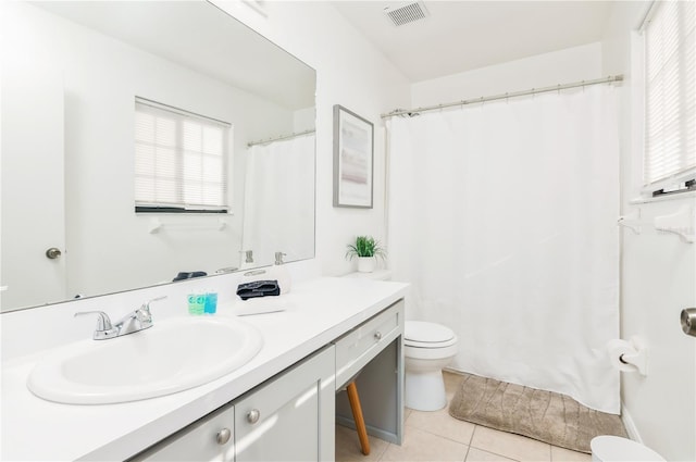 bathroom featuring vanity, tile patterned floors, and toilet