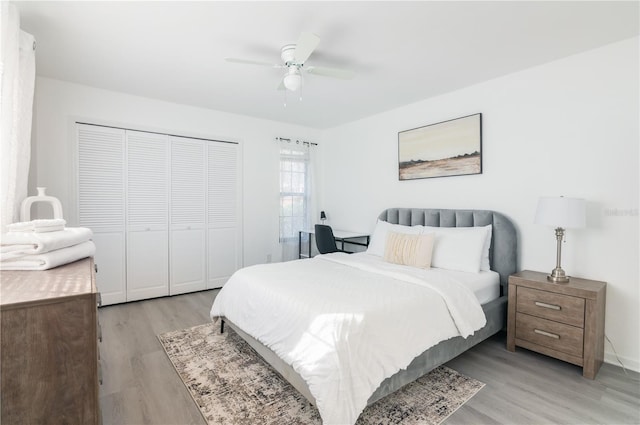 bedroom featuring ceiling fan, a closet, and light hardwood / wood-style flooring