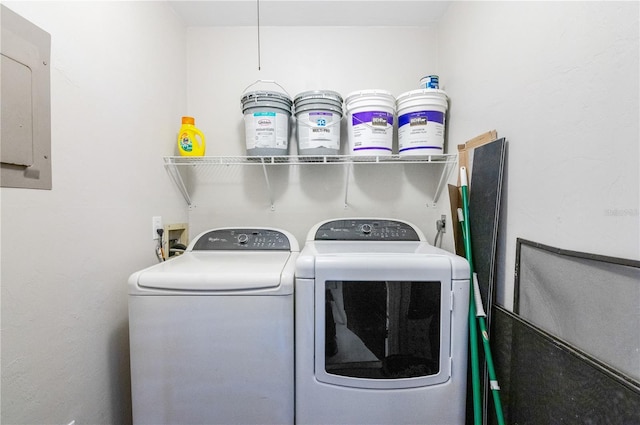 clothes washing area with washing machine and clothes dryer and electric panel