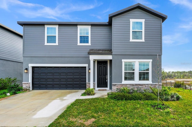 view of front facade with a garage and a front yard