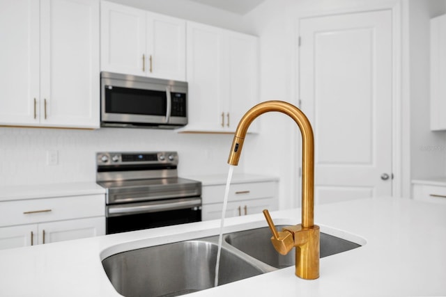 kitchen featuring white cabinetry, sink, and stainless steel appliances