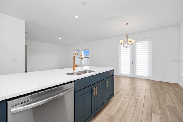 kitchen with a wealth of natural light, dishwasher, sink, hanging light fixtures, and light hardwood / wood-style flooring