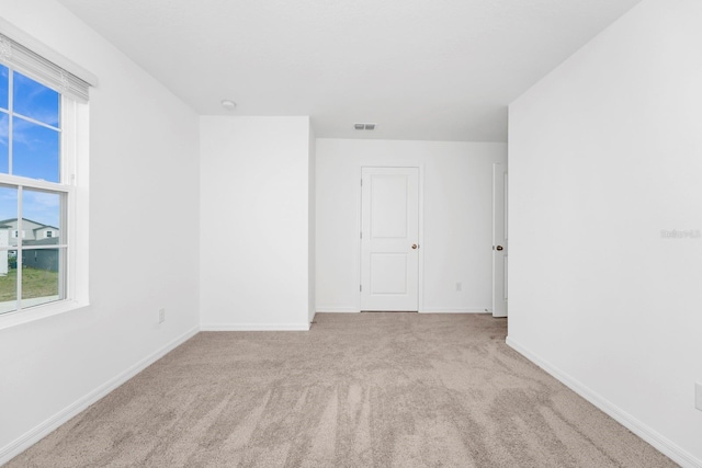 spare room with light carpet