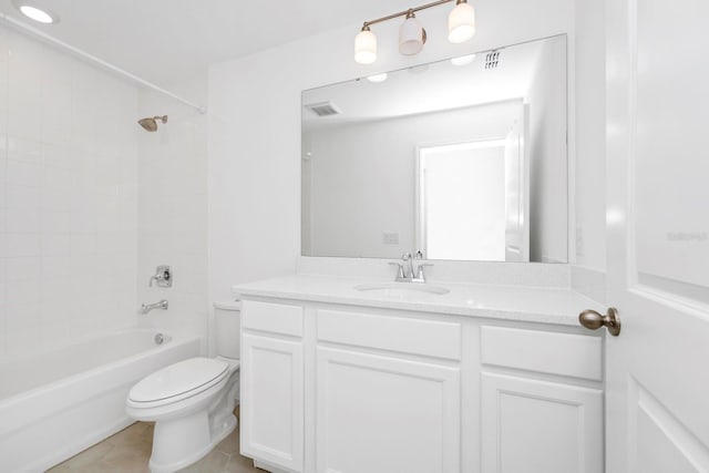 full bathroom with tile patterned flooring, vanity, tiled shower / bath combo, and toilet