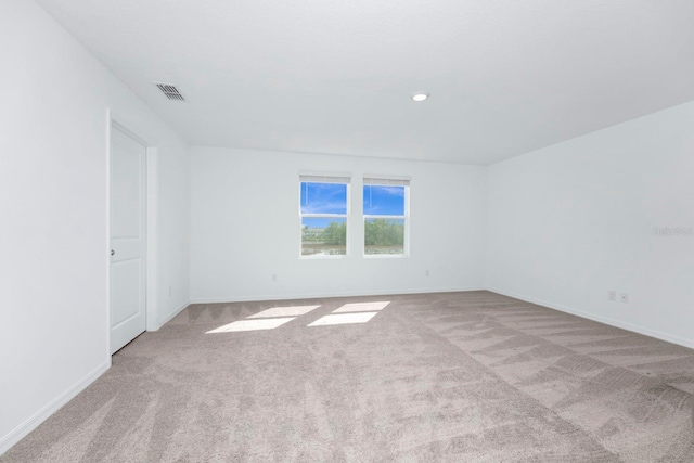 empty room featuring light colored carpet