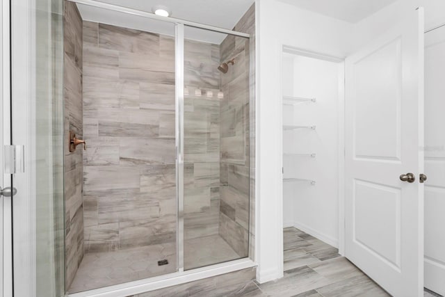 bathroom featuring a shower with shower door