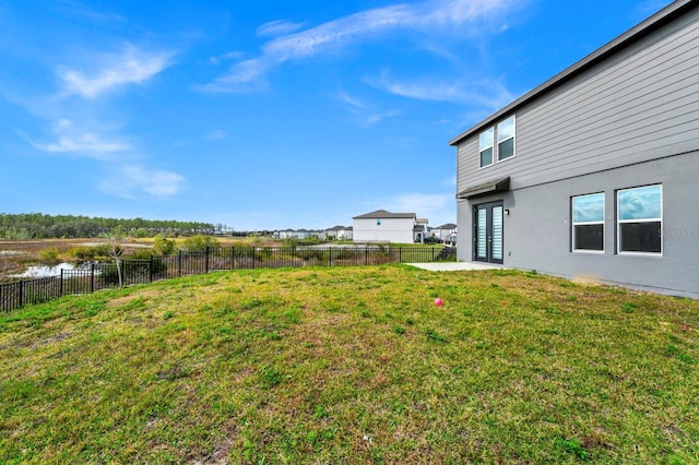 view of yard with a water view and french doors