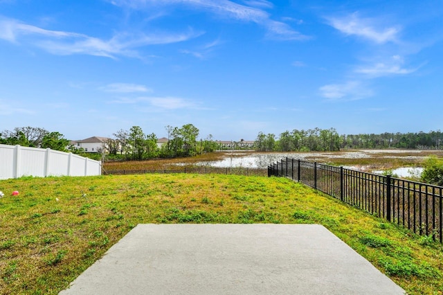 view of yard with a water view and a patio area