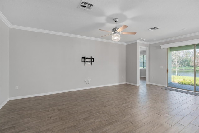 spare room featuring hardwood / wood-style flooring, ornamental molding, and ceiling fan