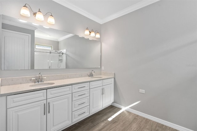 bathroom with crown molding, wood-type flooring, vanity, and walk in shower