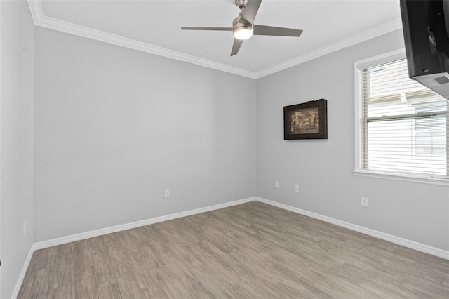 spare room featuring ceiling fan, ornamental molding, and light wood-type flooring