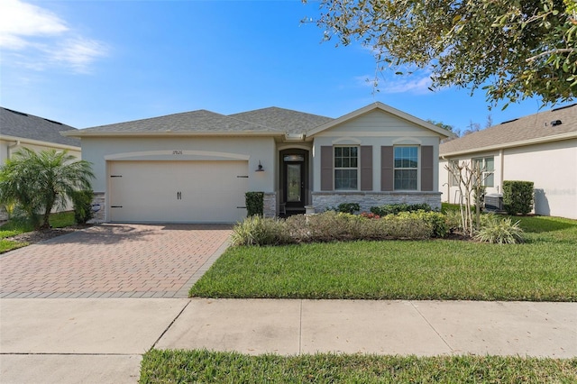 view of front of property with a garage, decorative driveway, stone siding, and stucco siding