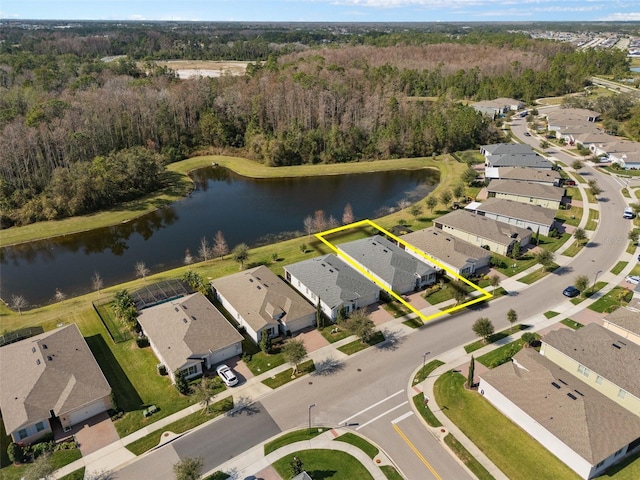 bird's eye view featuring a forest view, a water view, and a residential view