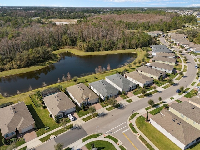 bird's eye view featuring a water view, a wooded view, and a residential view