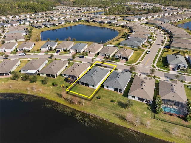 bird's eye view featuring a residential view and a water view