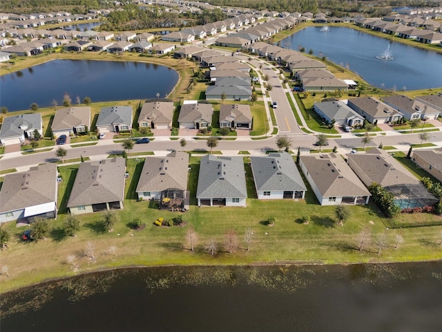 birds eye view of property featuring a water view and a residential view