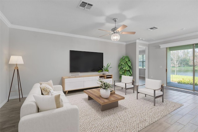 living room featuring crown molding, ceiling fan, and light wood-type flooring