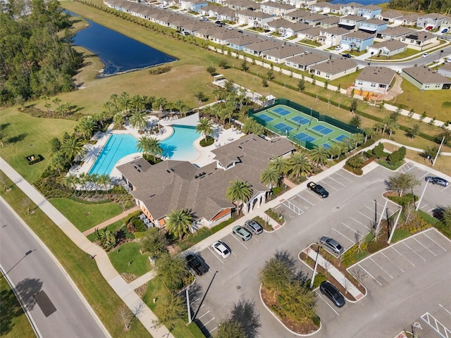 drone / aerial view featuring a residential view and a water view