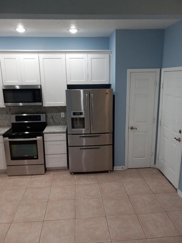 kitchen featuring white cabinetry, light tile patterned floors, and appliances with stainless steel finishes