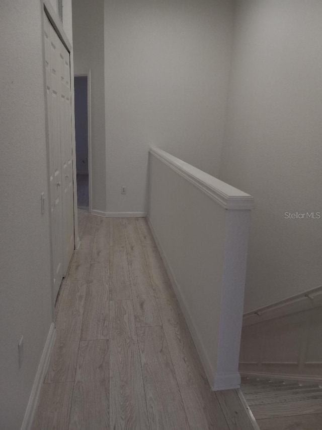 hallway with light hardwood / wood-style flooring