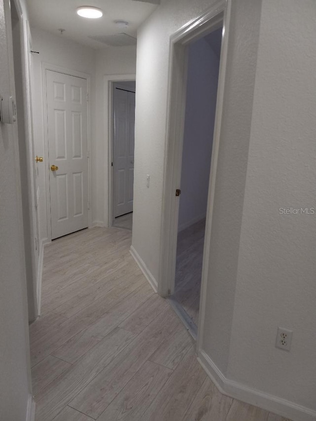 hall with light hardwood / wood-style floors