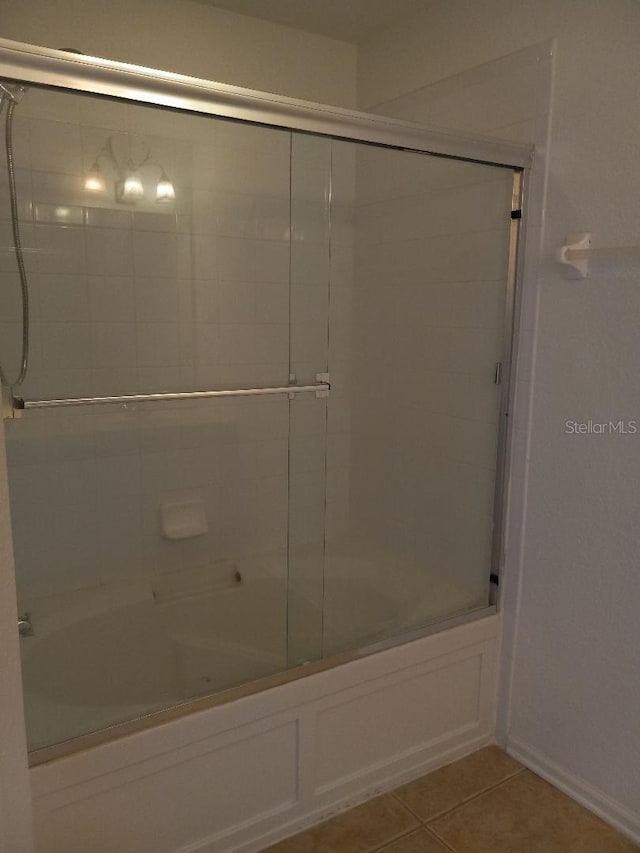 bathroom featuring enclosed tub / shower combo and tile patterned floors