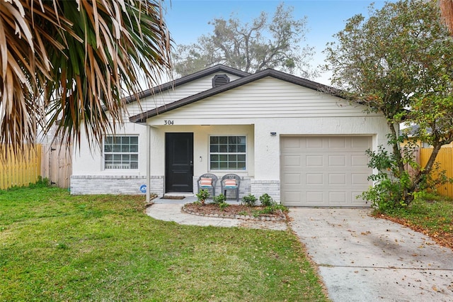 view of front of property featuring a garage and a front lawn