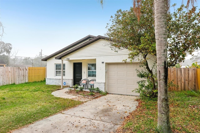 view of front of property with a garage and a front yard